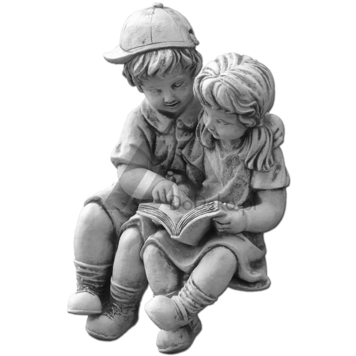 Estatuetas de crianças com um livro